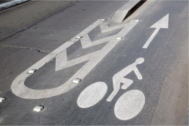 A street painted with a cyclist sign