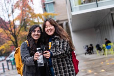 Two students cheersing outside the UBC library